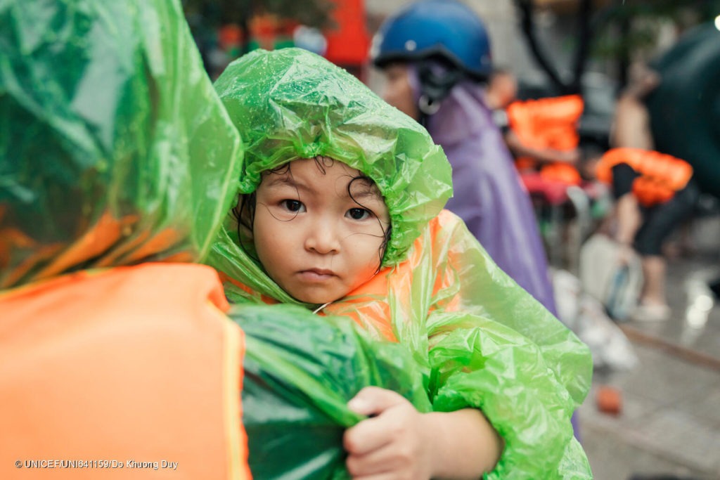 3-year old Vu Ha Anh is carried to safety from the severe flood caused by Super Typhoon Yagi in Viet Nam, September 2024.